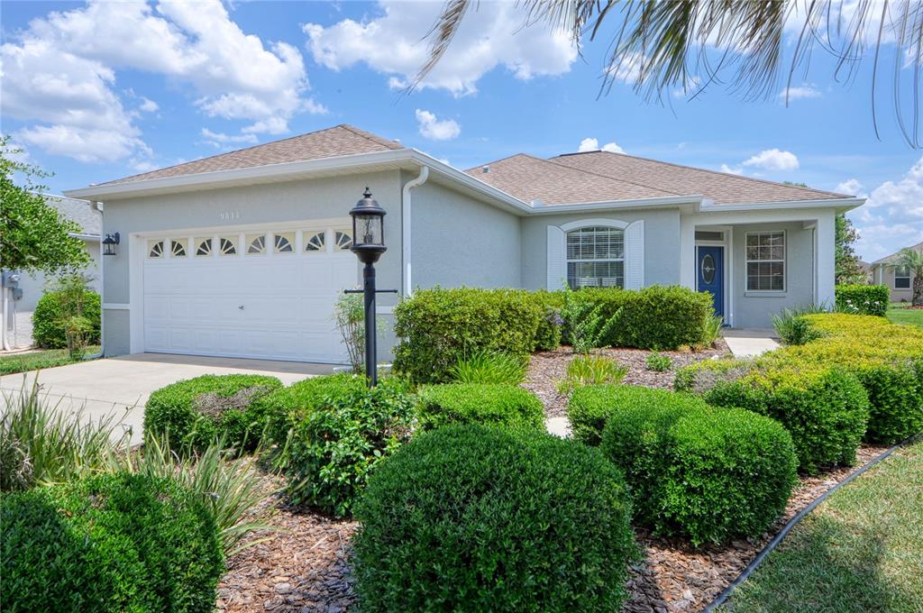 9818 Southwest 89th Loop Ocala, FL 34481 - Photo 1 of 1 a front view of a house with garden