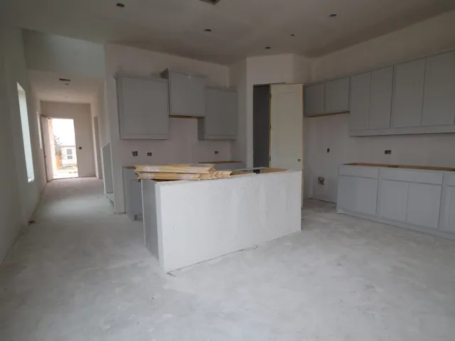 a utility room with cabinets washer and dryer