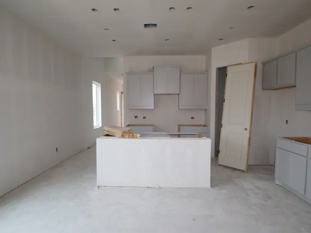 a kitchen with granite countertop a sink and cabinets
