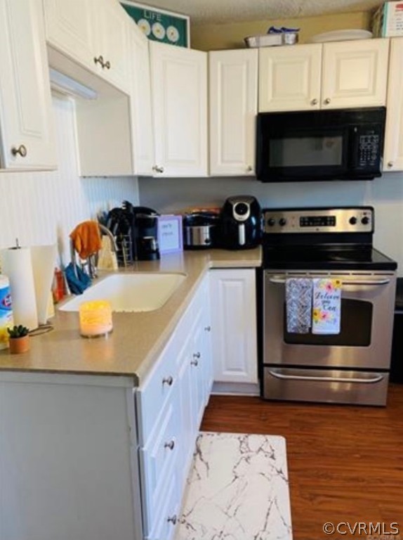 1400 Bangle Drive Richmond, VA 23224 - Photo 6 of 8 a kitchen with stainless steel appliances a stove a microwave a sink and a counter