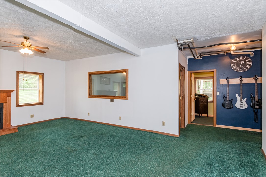 6750 Little Twin Road Germantown, OH 45327 - Photo 53 of 88 This living area features a warm fireplace and ample natural light, ideal for comfortable gatherings.