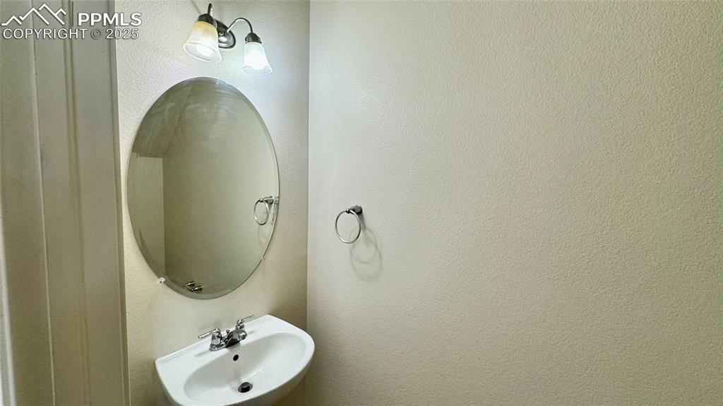 7354 Countryside Grove Fountain, CO 80817 - Photo 11 of 28 a bathroom with a sink and mirror