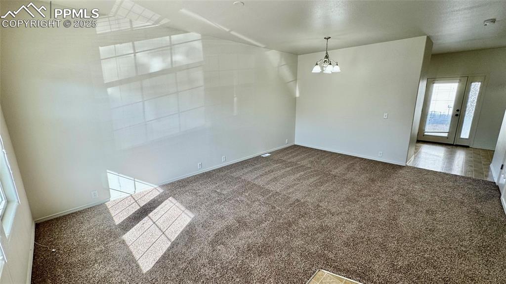 7354 Countryside Grove Fountain, CO 80817 - Photo 6 of 28 an empty room with chandelier fan and windows