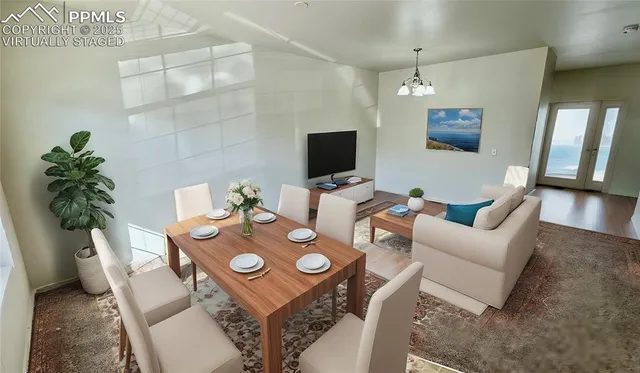 a view of a dining room with furniture and a potted plant