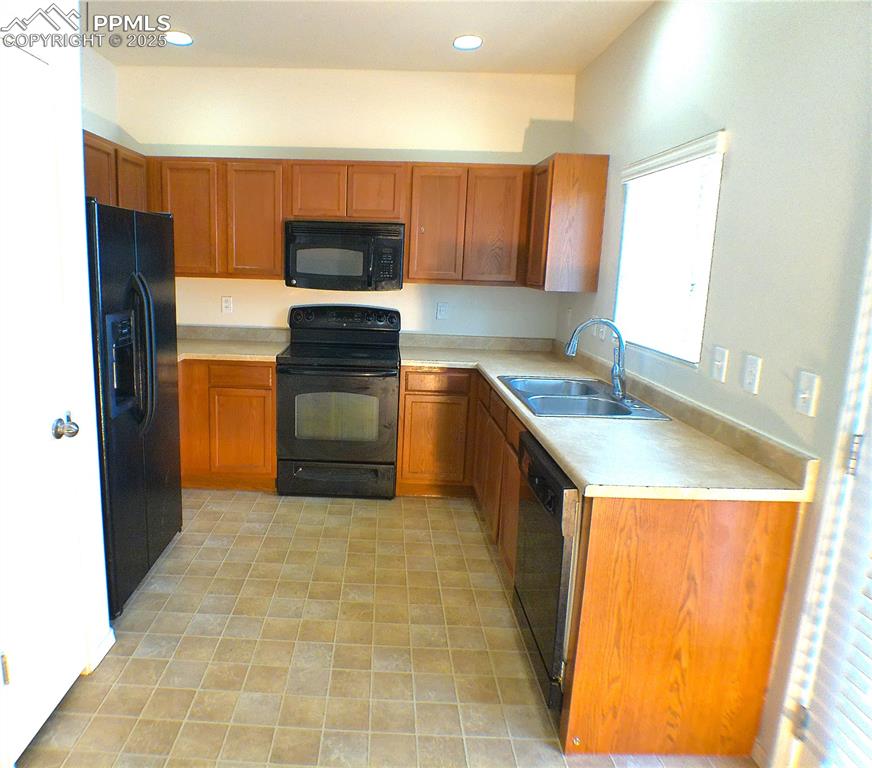7354 Countryside Grove Fountain, CO 80817 - Photo 8 of 28 a kitchen with stainless steel appliances granite countertop a stove a sink and a refrigerator