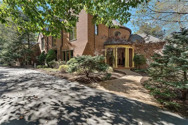 a front view of a house with garden