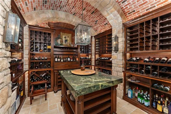 a table with wine bottles and glasses in front of it