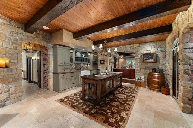 a kitchen with refrigerator and cabinets