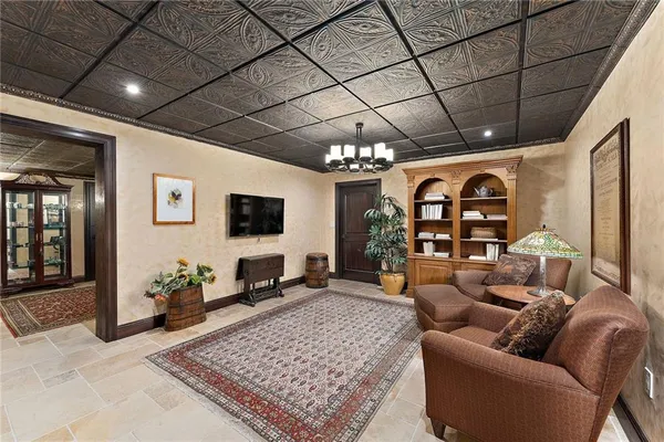 a living room with furniture and a chandelier