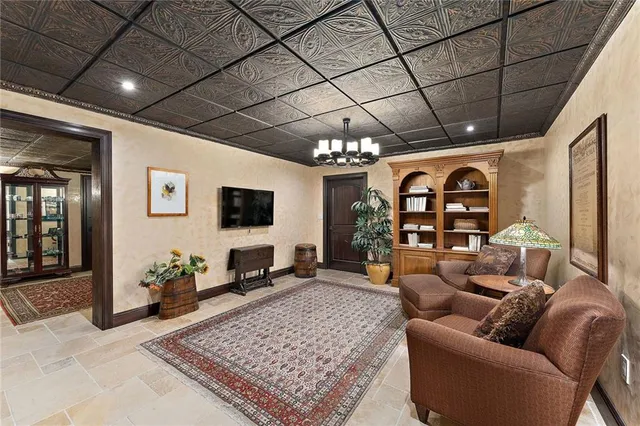 a living room with furniture and a chandelier