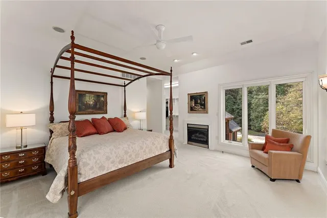 a bedroom with a bed couch and fireplace