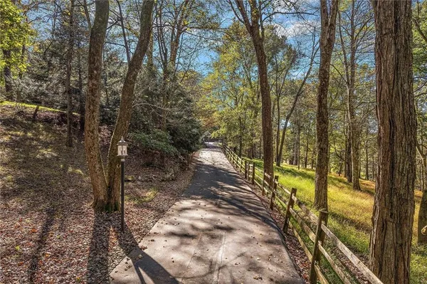 a view of a yard with wooden fence