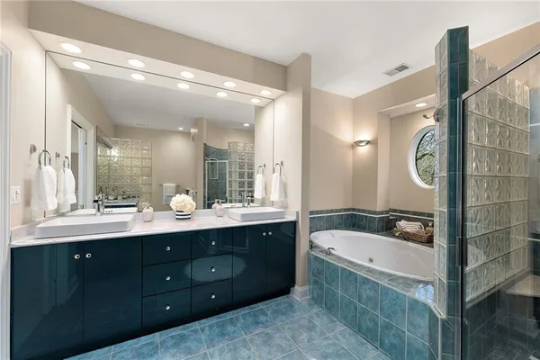 a bathroom with a sink mirror and a bathtub