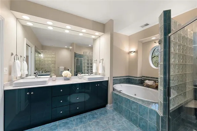 a bathroom with a sink mirror and a bathtub