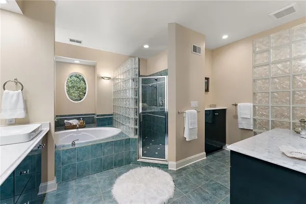 a bathroom with a granite countertop sink a toilet a shower and mirror