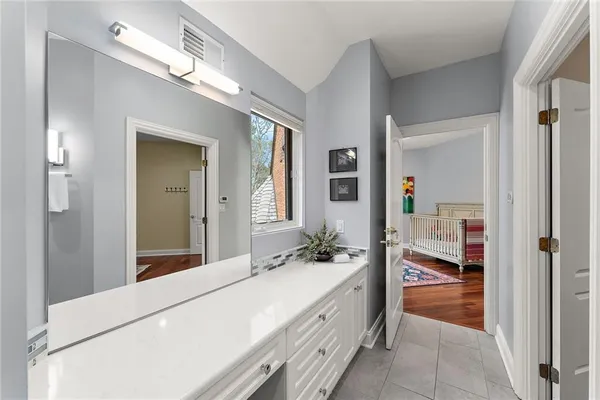 a bathroom with a double vanity sink and a mirror