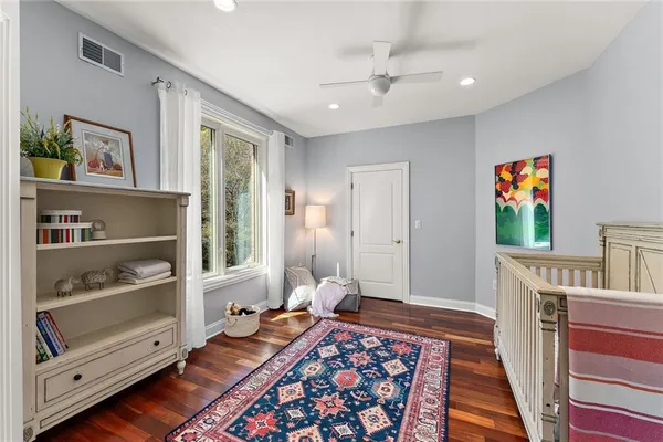 a bedroom with furniture and a rug