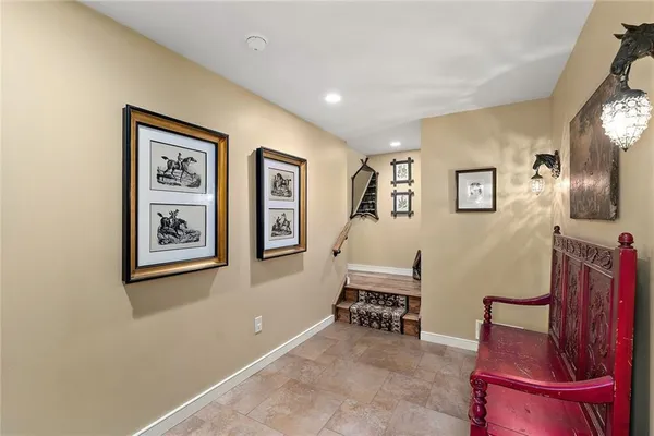 a living room with furniture and paintings on the wall