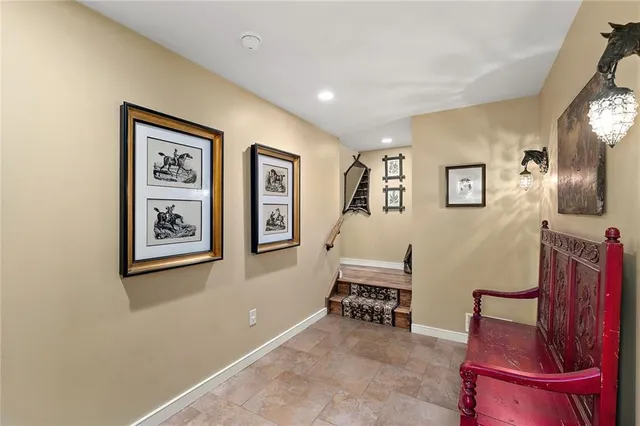 a living room with furniture and paintings on the wall