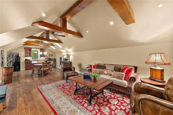a living room with furniture a rug and white walls