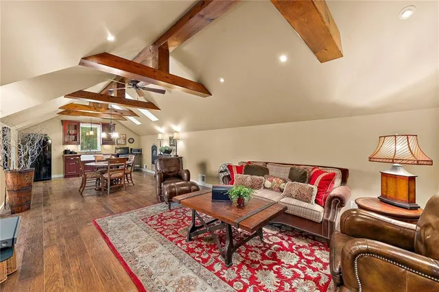 a living room with furniture a rug and white walls