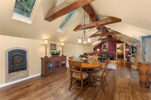 a dining room with furniture and wooden floor