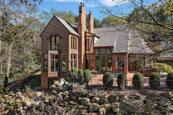 a view of a house with backyard and sitting area