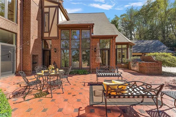 a view of a patio with table and chairs and potted plants