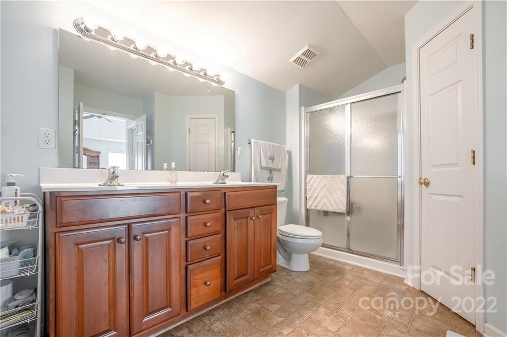 5511 Alexandrite Way Fort Mill, SC 29708 - Photo 18 of 32 a bathroom with a double vanity sink a toilet and a mirror