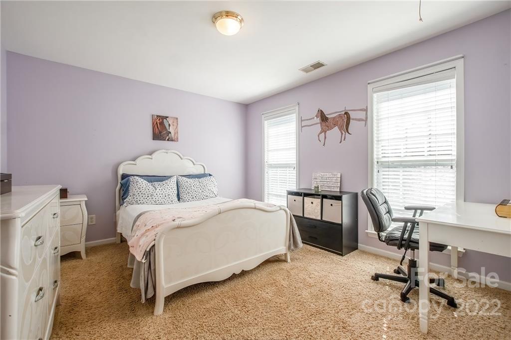 5511 Alexandrite Way Fort Mill, SC 29708 - Photo 20 of 32 a bedroom with a bed and a table