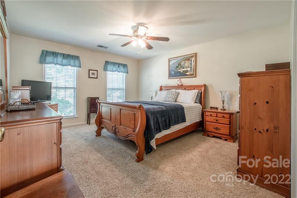 5511 Alexandrite Way Fort Mill, SC 29708 - Photo 21 of 32 a bedroom with a bed and furniture