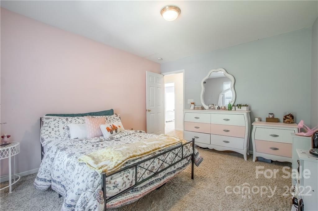 5511 Alexandrite Way Fort Mill, SC 29708 - Photo 22 of 32 a bedroom with a bed and a dresser