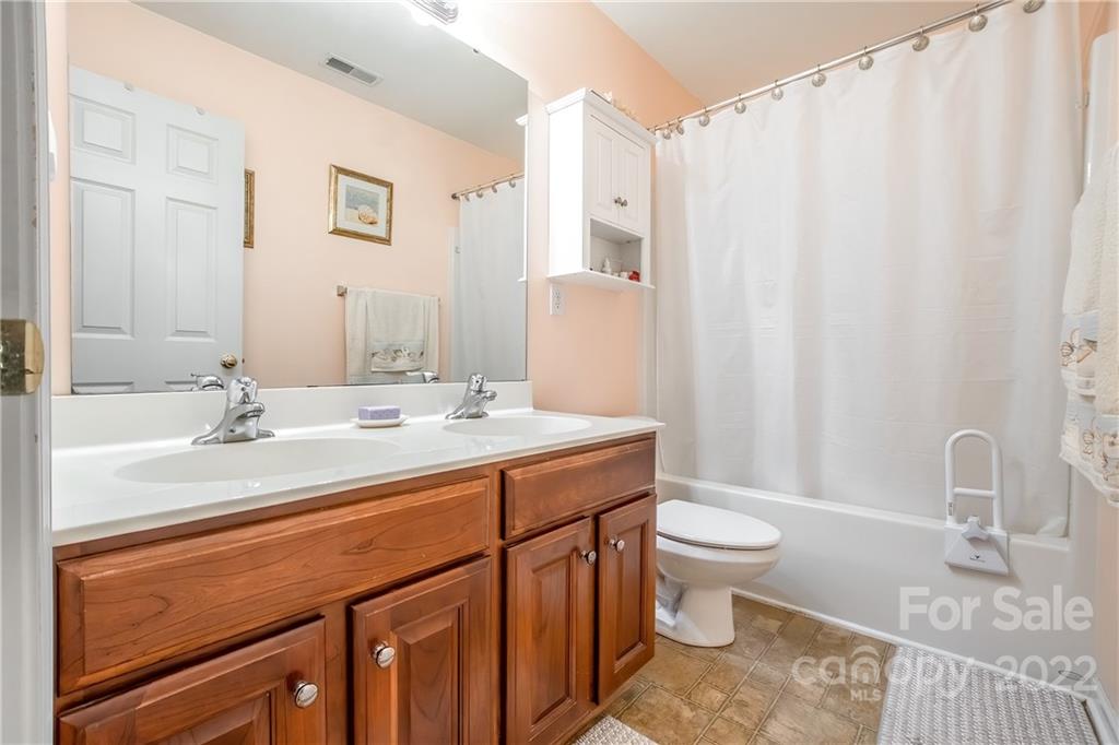 5511 Alexandrite Way Fort Mill, SC 29708 - Photo 23 of 32 a bathroom with a sink a toilet and a mirror