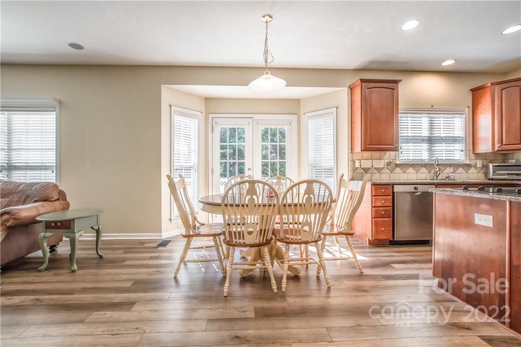 5511 Alexandrite Way Fort Mill, SC 29708 - Photo 7 of 32 a dining room with furniture a chandelier and wooden floor