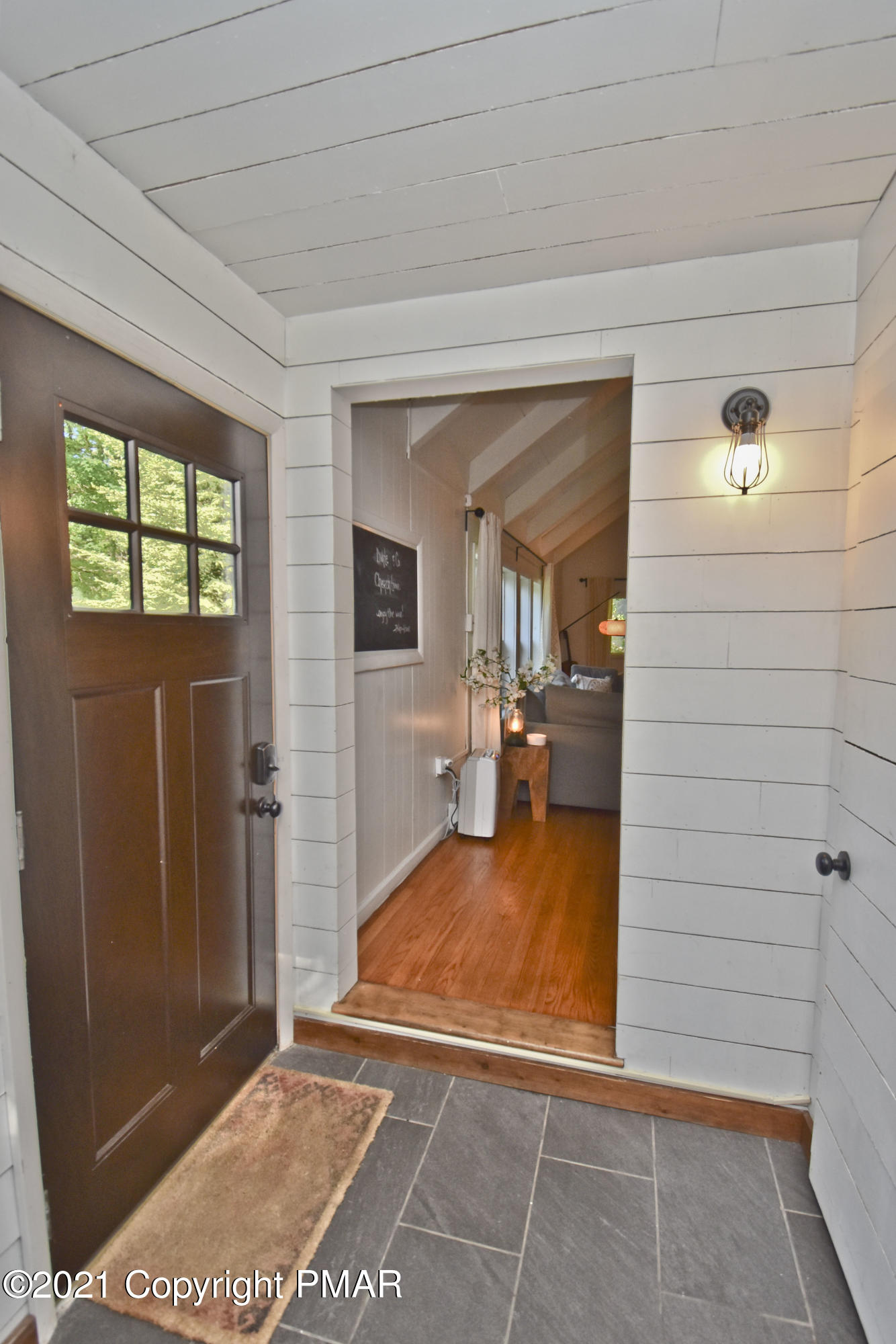5160 Pine Tree Road Pocono Summit, PA 18346 - Photo 3 of 48 a view of a livingroom with wooden floor and kitchen view