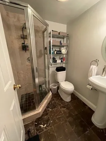 a bathroom with a toilet and a shower