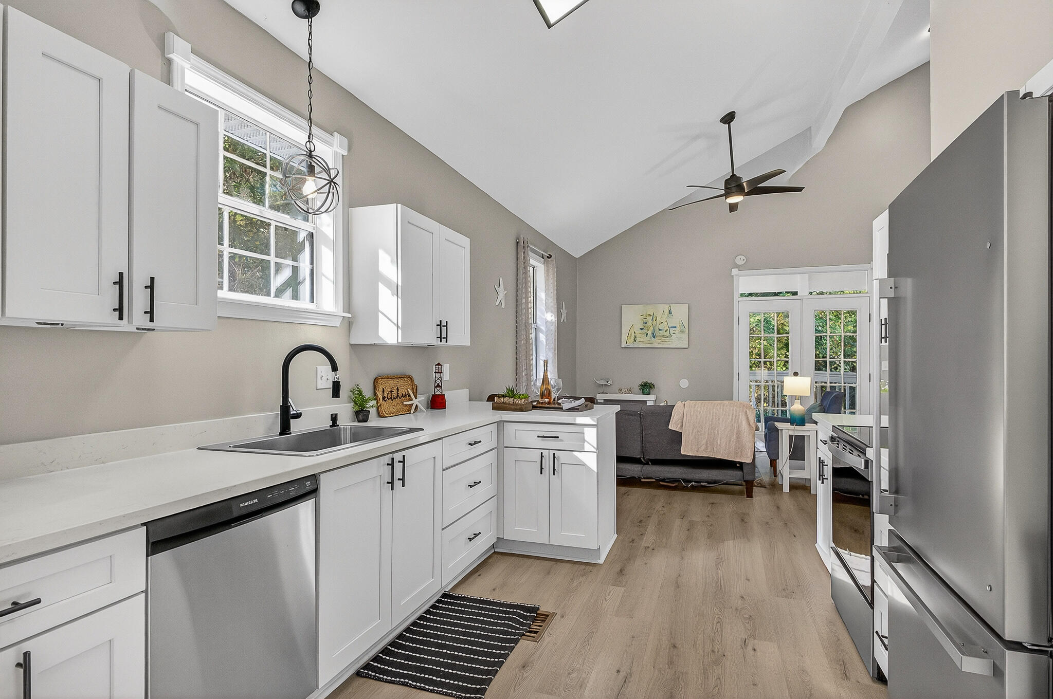 115 Central 6th Street Santa Rosa Beach, FL 32459 - Photo 14 of 56 a kitchen with sink cabinets and wooden floor