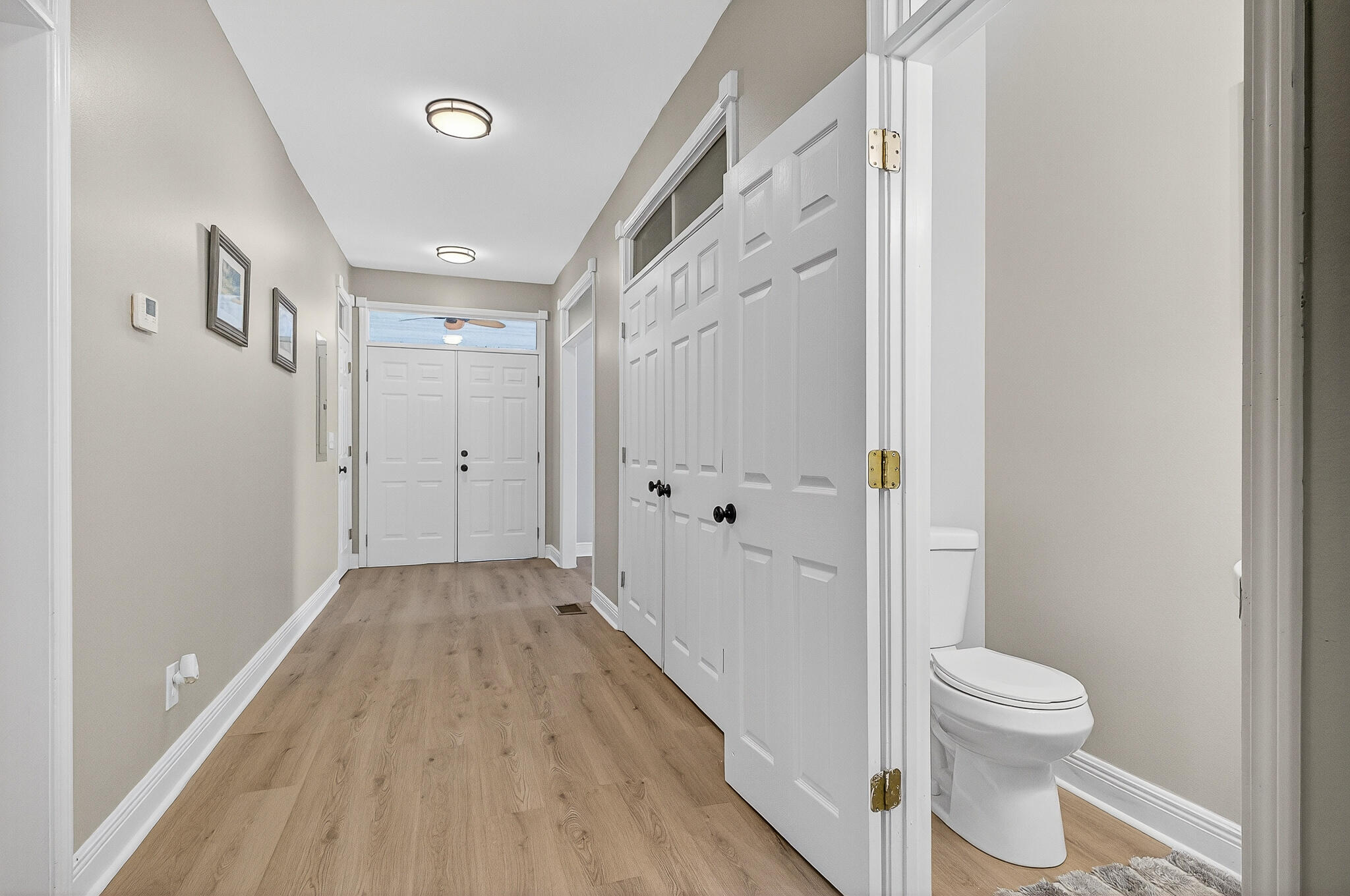 115 Central 6th Street Santa Rosa Beach, FL 32459 - Photo 37 of 56 a view of a hallway with wooden floor and a bathroom