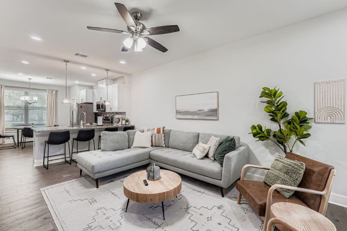 18803 Hogan Circle, Unit 14 Point Venture, TX 78645 - Photo 1 of 40 a living room with furniture potted plant and a ceiling fan