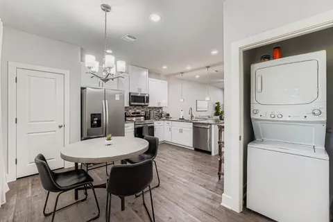 a view of a dining room with furniture and a window