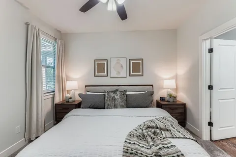 a bedroom with a bed and a chandelier