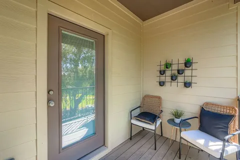 a bedroom with a bed and painting on the wall