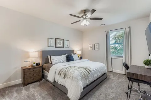 a spacious bathroom with a granite countertop sink and a mirror