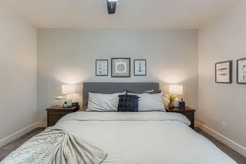 a bedroom with a large bed and a chandelier