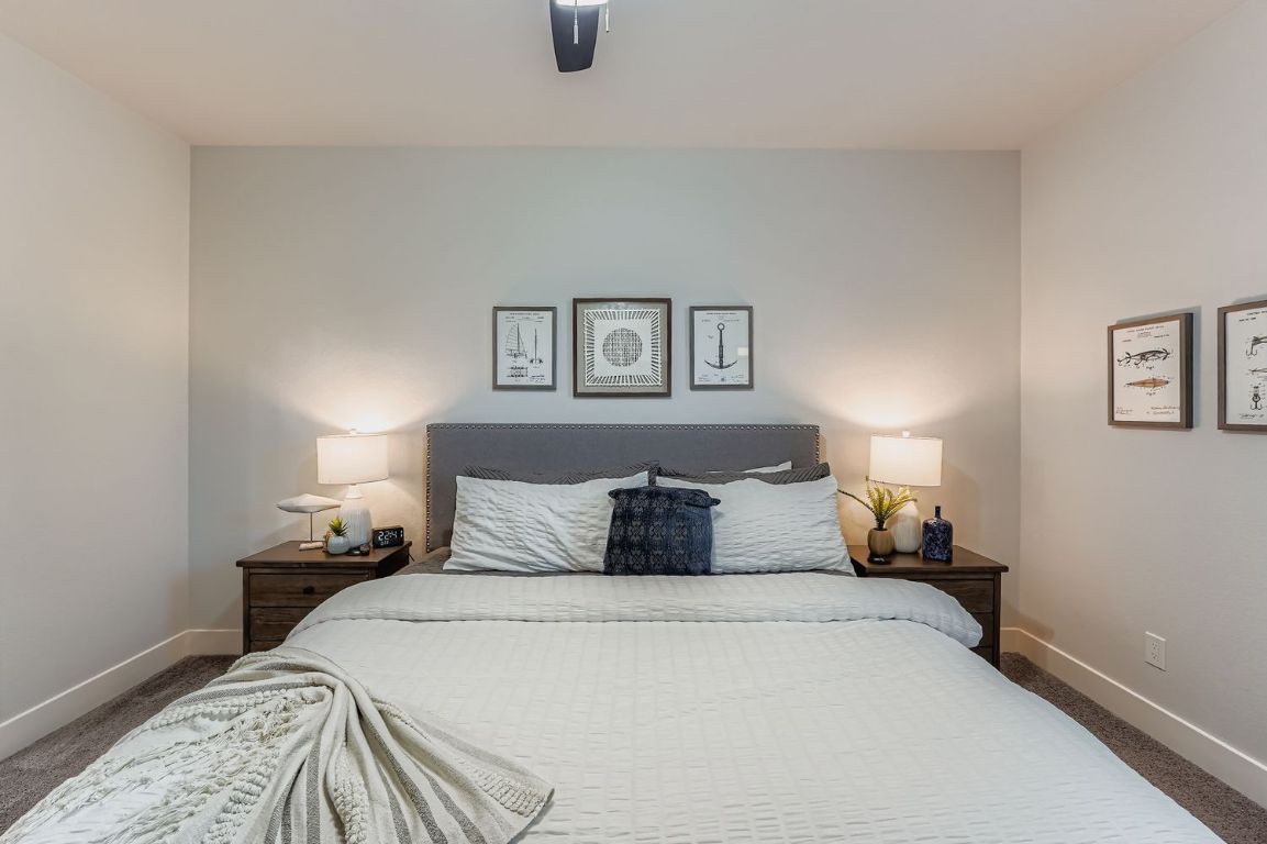 18803 Hogan Circle, Unit 14 Point Venture, TX 78645 - Photo 21 of 40 a bedroom with a bed and a window