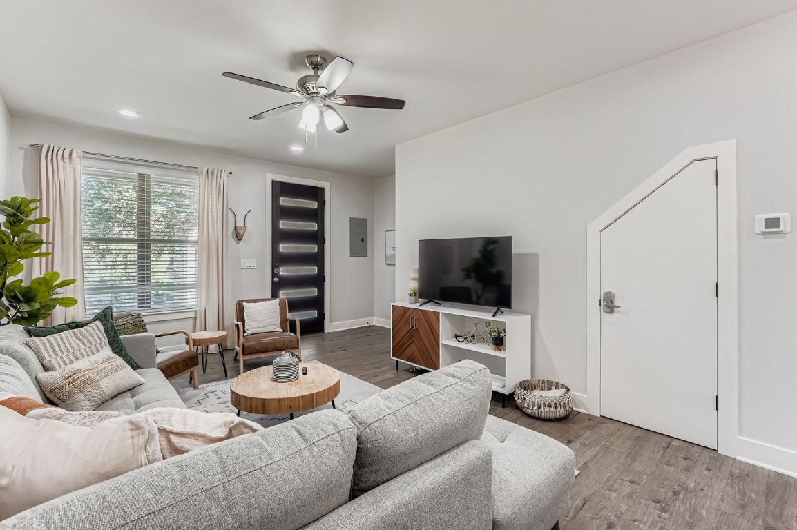 18803 Hogan Circle, Unit 14 Point Venture, TX 78645 - Photo 3 of 40 a living room with furniture and a flat screen tv