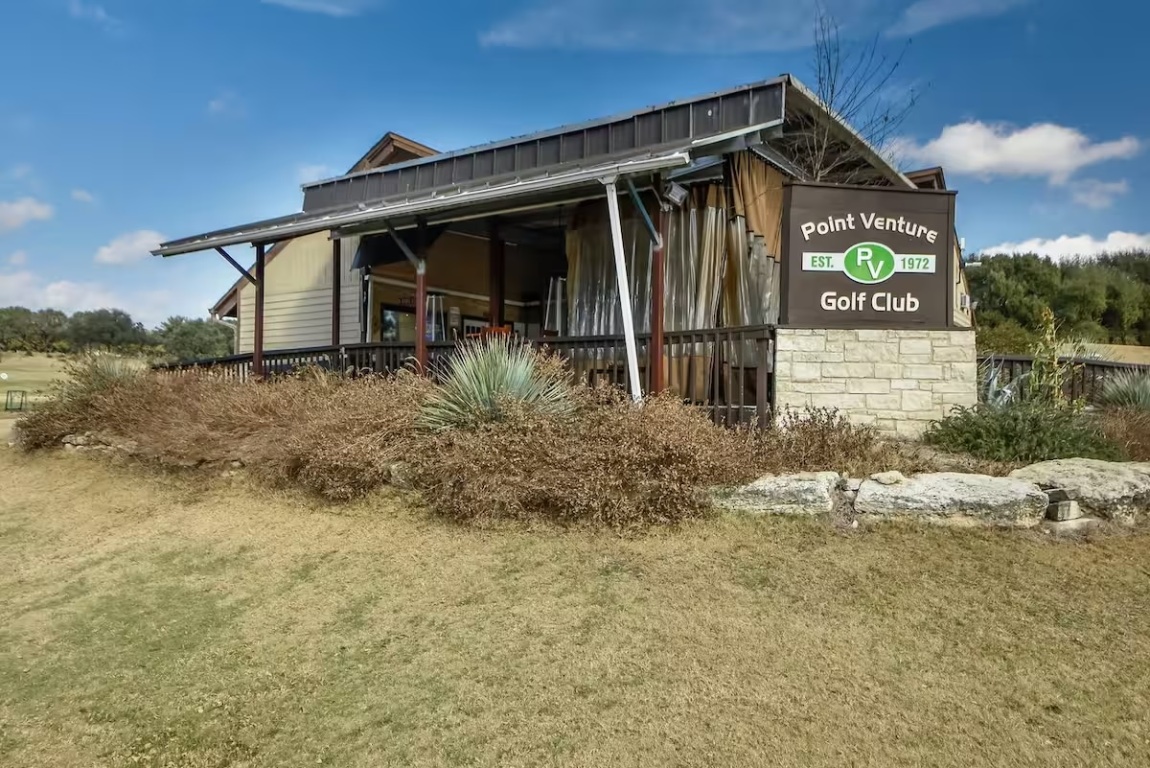 18803 Hogan Circle, Unit 14 Point Venture, TX 78645 - Photo 35 of 40 a front view of a house with garden