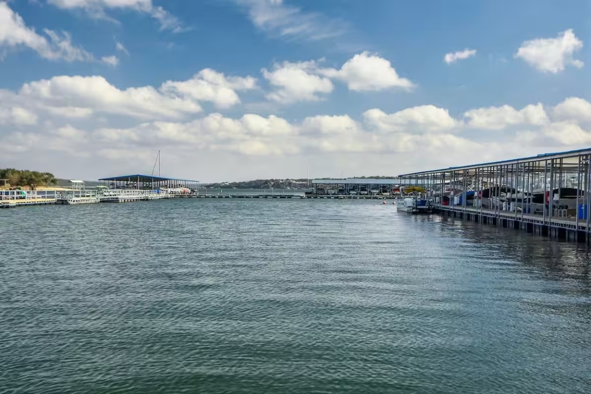 18803 Hogan Circle, Unit 14 Point Venture, TX 78645 - Photo 36 of 40 a view of a lake with boats in front of it