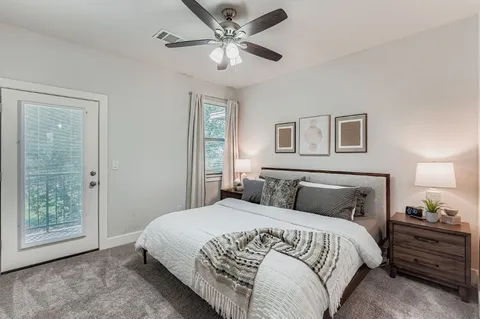 a bedroom with a large bed and a chandelier