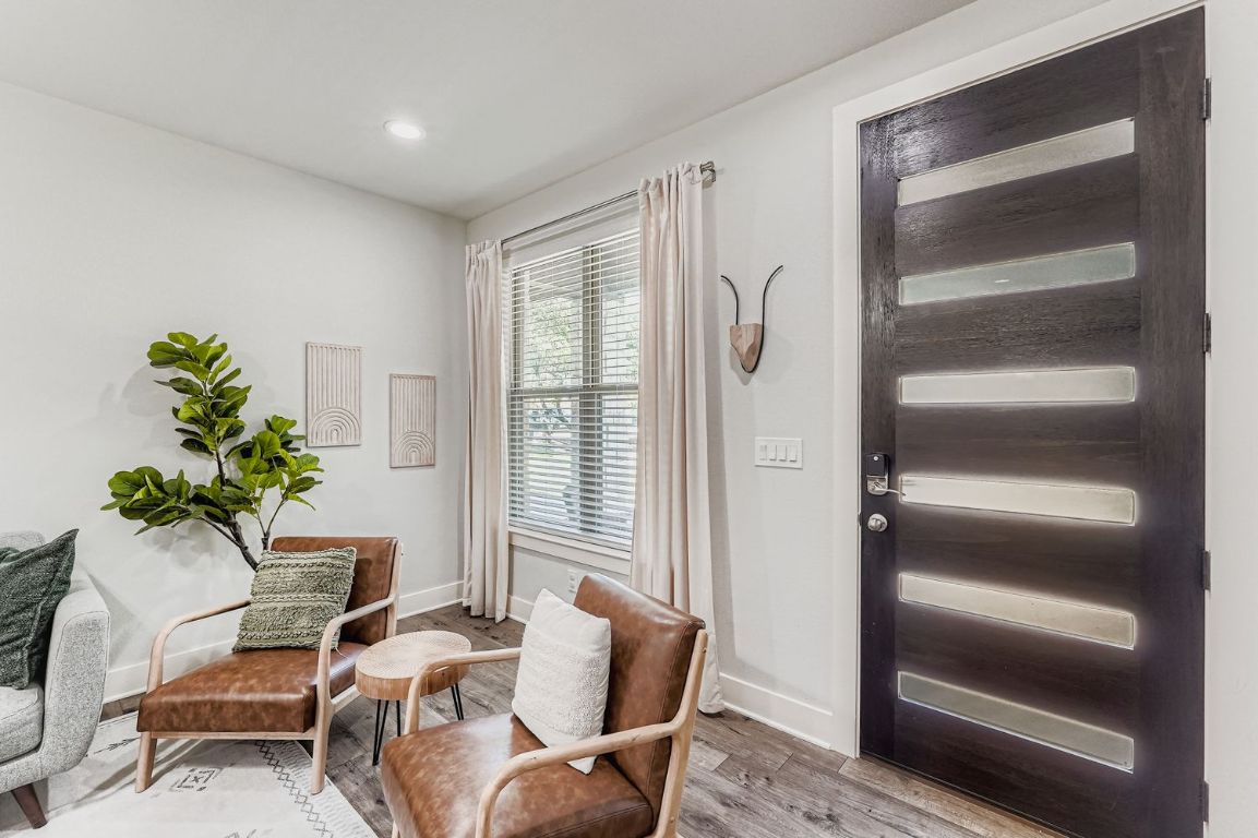 18803 Hogan Circle, Unit 14 Point Venture, TX 78645 - Photo 7 of 40 a living room with furniture and a potted plant